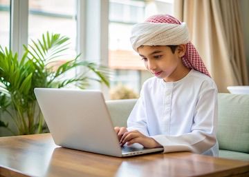 Arab boy in traditional dress learning online
