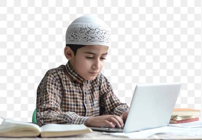 Focused Muslim student studying with books and laptop