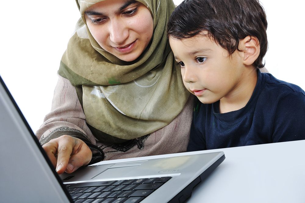 Tutor teaching a child in a live online Quran class